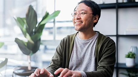 Man smiling while working at his desk