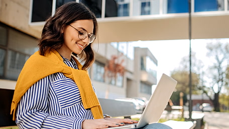 Woman working on her laptop outdoors