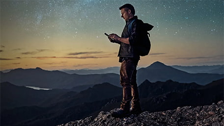 Man hiking at night in the mountains