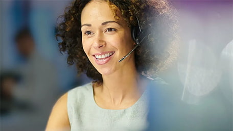 Associate smiling while wearing a headset