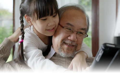 A man and his granchild looking at a tablet