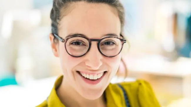 A smiling woman with glasses