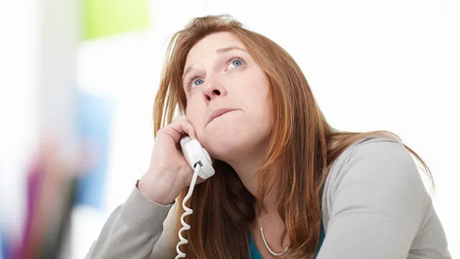 A woman talking to someone on the telephone