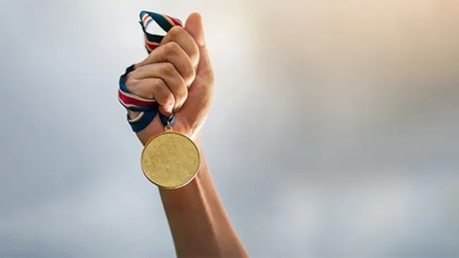 Holding a gold medal