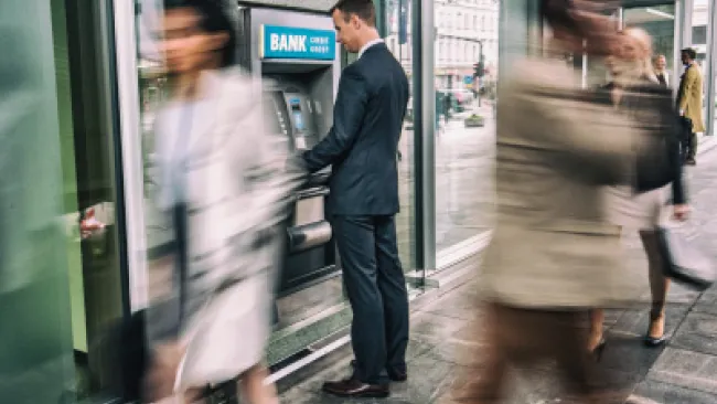 A man transacting at the ATM