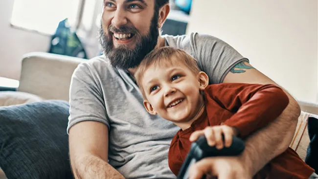 Man and son playing a video game