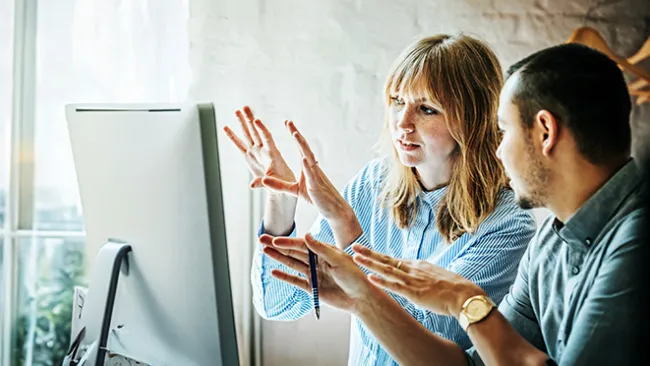 Woman and man looking at a computer screen.