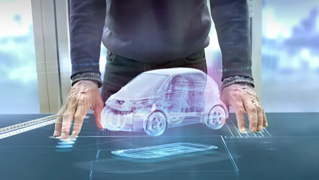 Digital image of a car on a table, in between two hands
