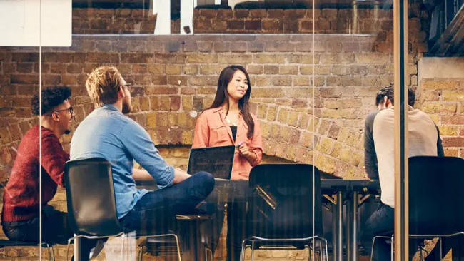 Group talking at table in office setting