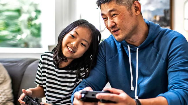Father and daughter playing a video game 