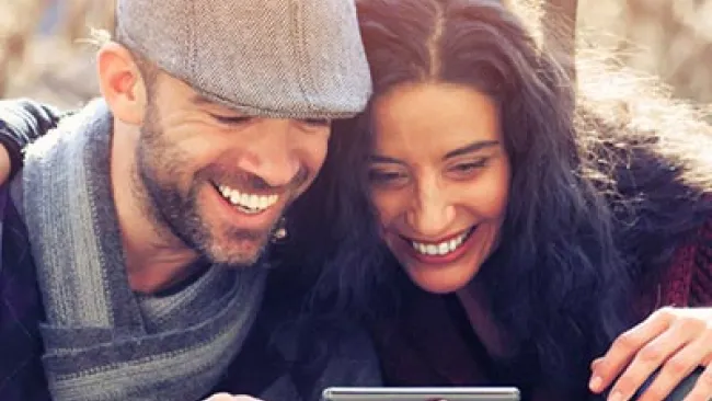 Man and woman sharing a tablet screen