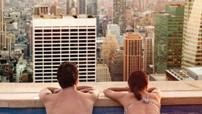 A couple relaxing on a rooftop pool