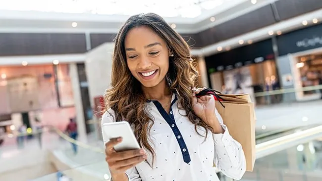 Woman in a shopping mall using her phone