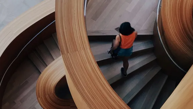 Woman walking up staircase