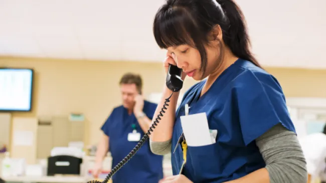 Female doctor or nurse on a phone call in a hospital