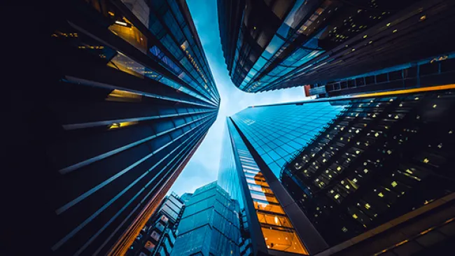 An upward-looking view of skyscrapers from ground level