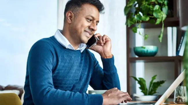 person on computer and phone