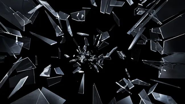 Glass shattering against a black background