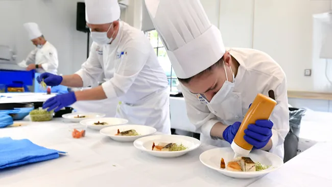 Chefs plating food 