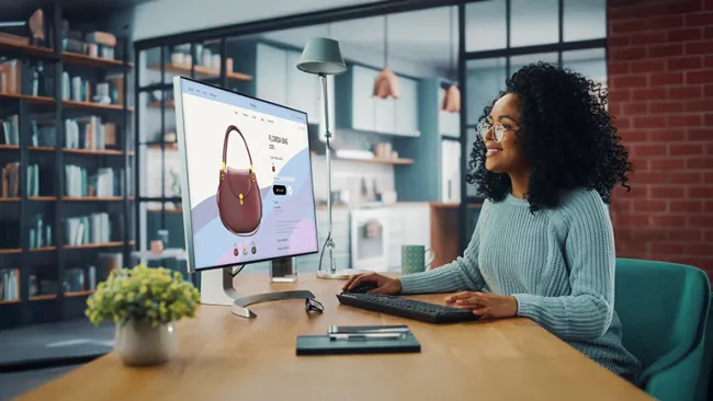 Woman looking at handbags on computer screen