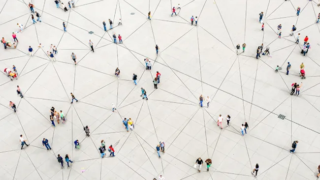 A high-level view from above of people walking, with lines between them, showing they are all connected 