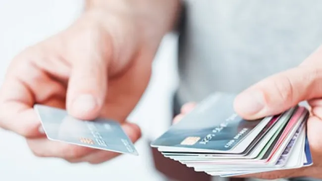 Man holding multiple credit cards in his hands