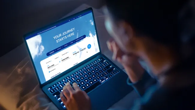 Person looking at a laptop that says "Your journey starts here" on screen.