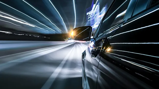 A car driving quickly with it's blinker on