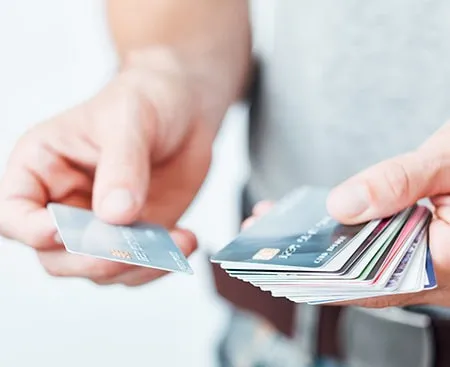 Man holding multiple credit cards in his hands