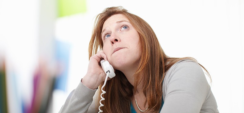 A woman talking to someone on the telephone