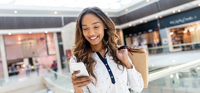 Woman in a shopping mall using her phone