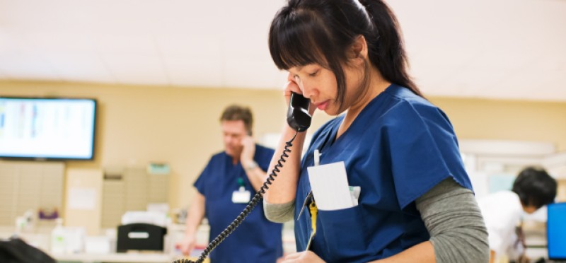 Female doctor or nurse on a phone call in a hospital