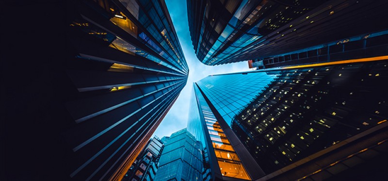 An upward-looking view of skyscrapers from ground level