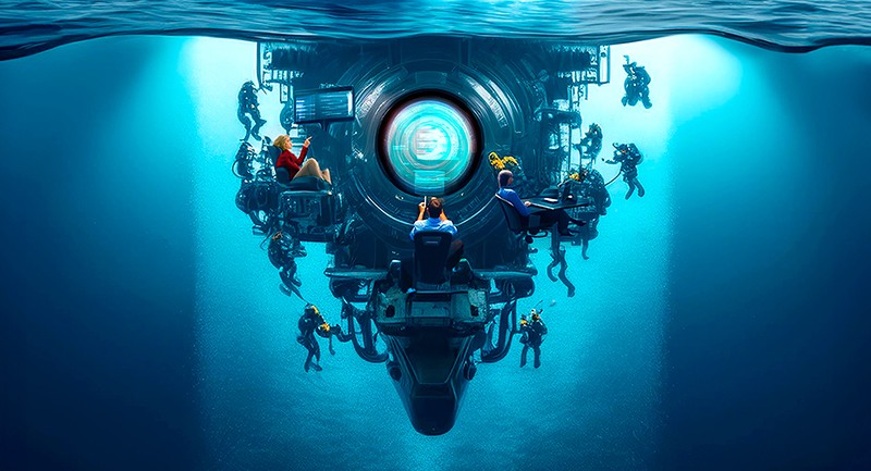 People working alongside a submarine underwater, at desks