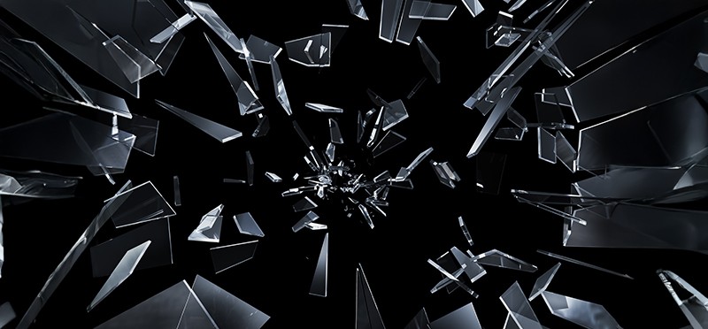 Glass shattering against a black background