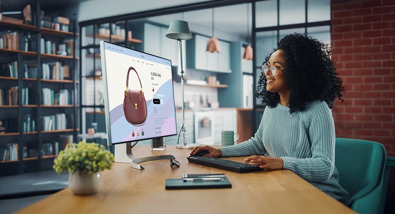 Woman looking at handbags on computer screen