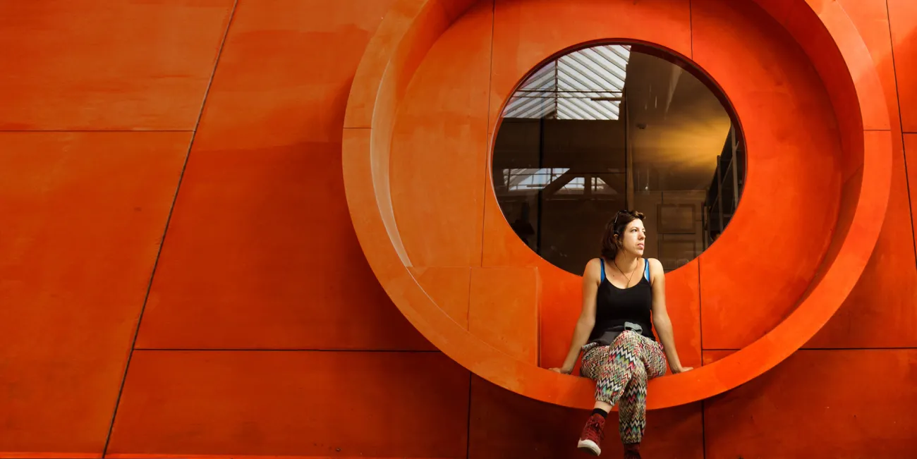 Woman sitting on artistic bench that is built into the wall