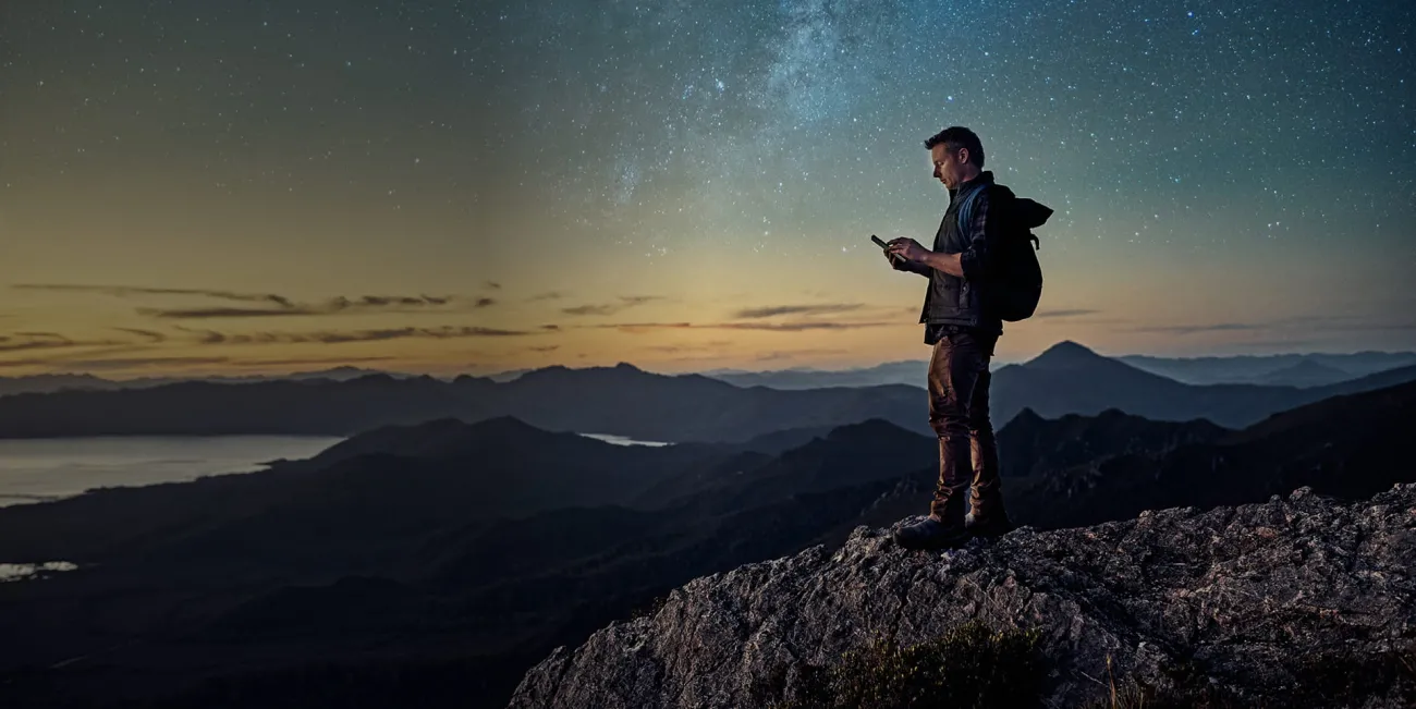 Man standing on mountain at dusk