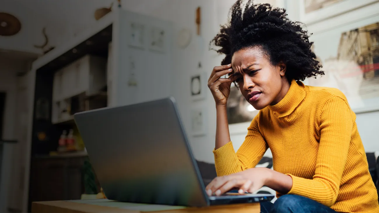 Woman looking frustrated while on her laptop