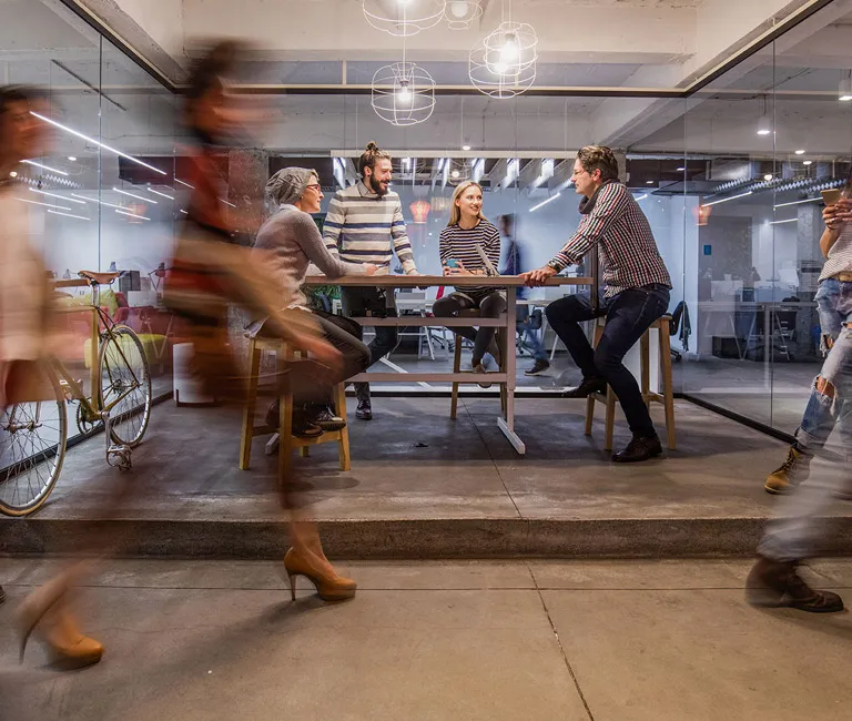 Group of people standing around table