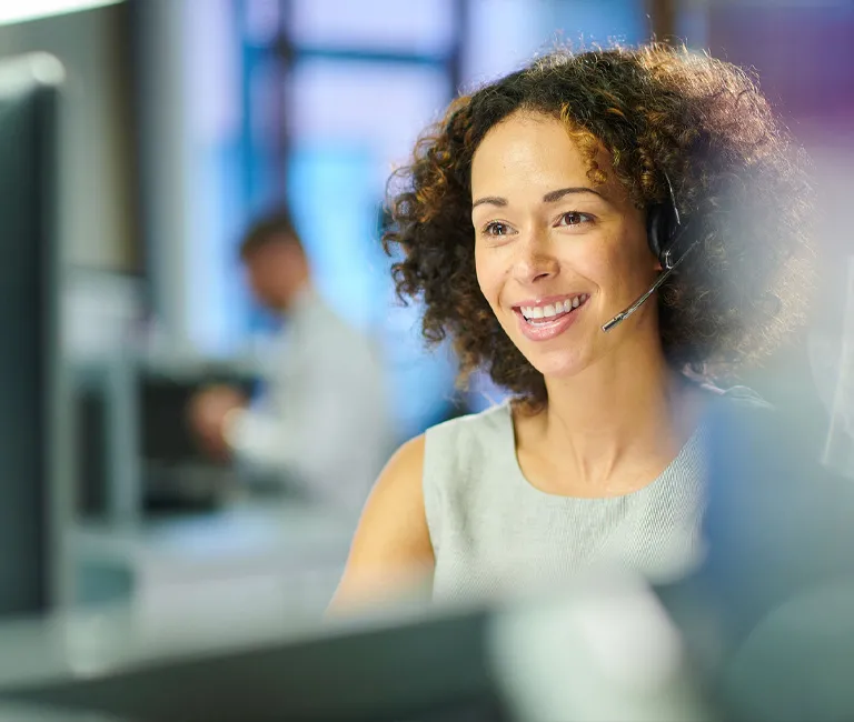 Contact center worker smiling while working