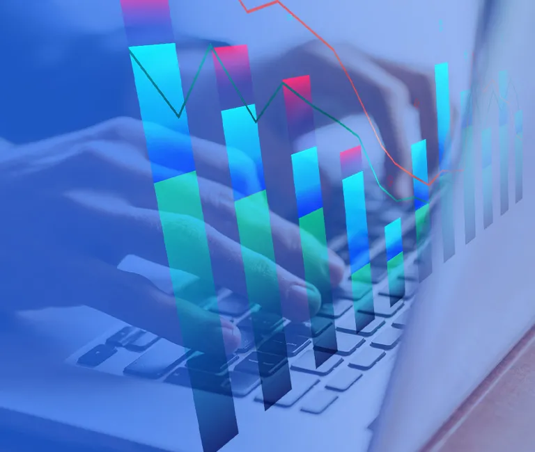 Bar charts overlayed over an image of a person using a laptop keyboard