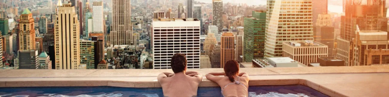 A couple relaxing on a rooftop pool