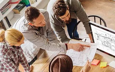 Group of employees looking at architectural drawings