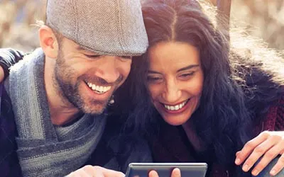 Man and woman sharing a tablet screen