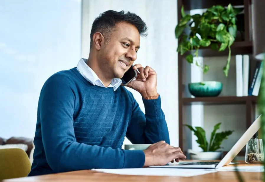 person on computer and phone