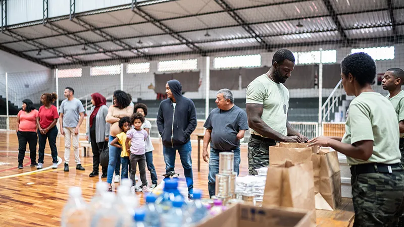 Volunteers handing out water bottles and food to disaster victims