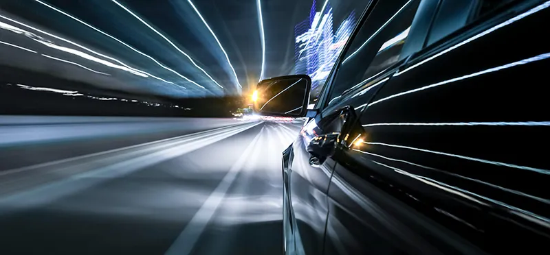 A car driving quickly with it's blinker on