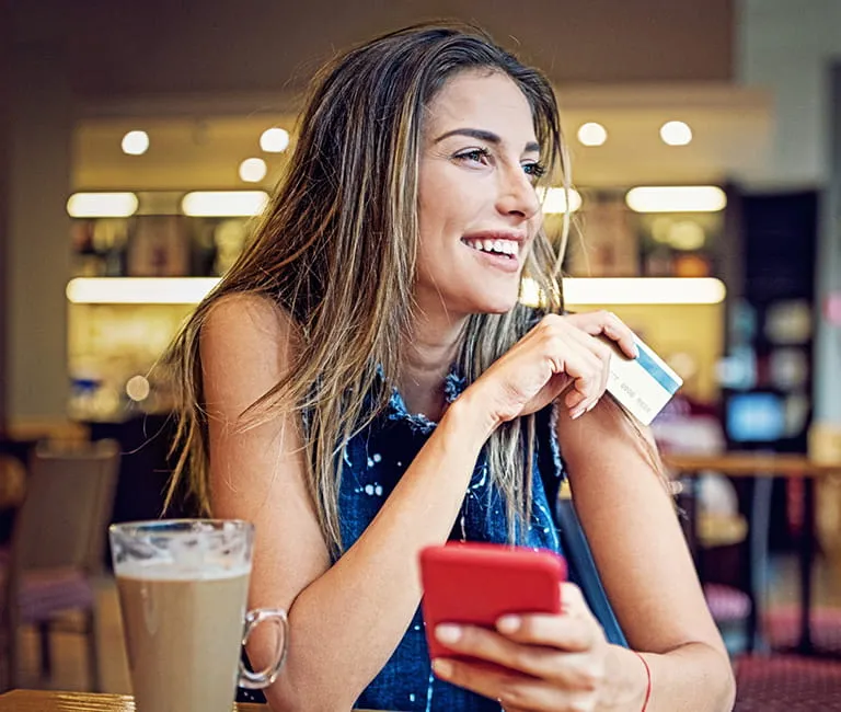 Woman holding phone while shopping