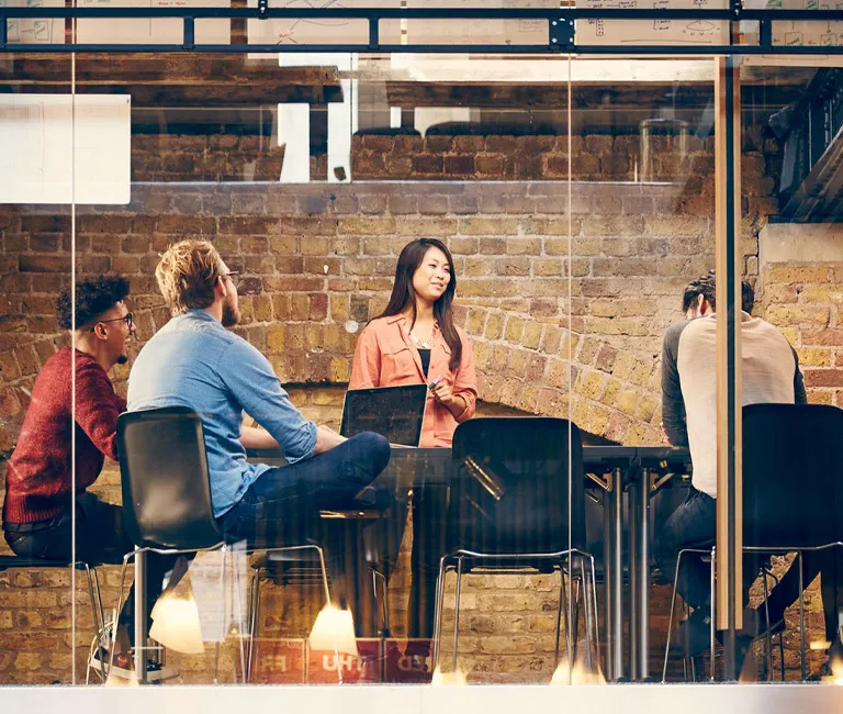 Group talking at table in office setting